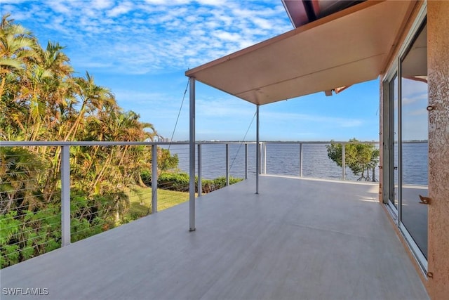 view of patio featuring a balcony and a water view