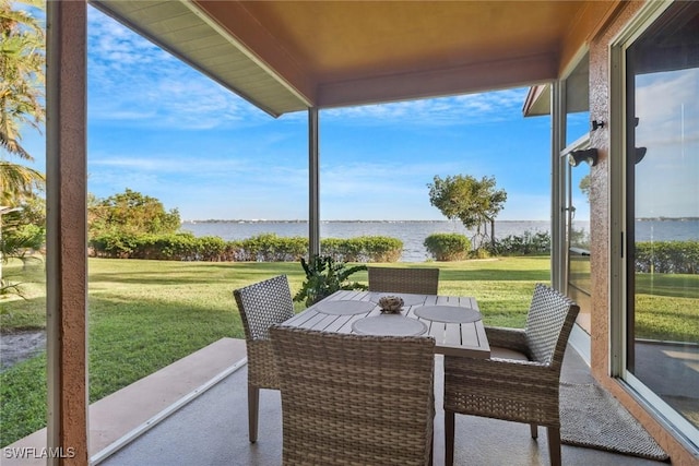 sunroom / solarium featuring a healthy amount of sunlight and a water view