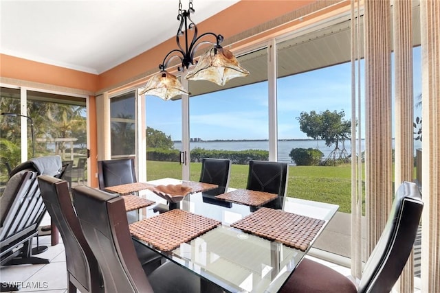 sunroom / solarium featuring a water view and an inviting chandelier