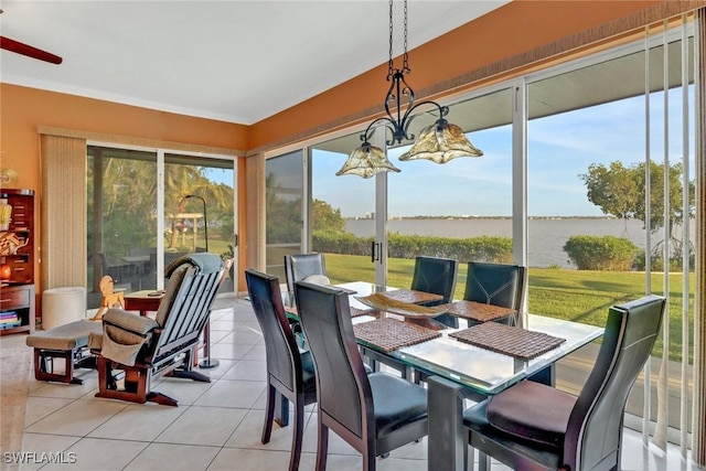 sunroom / solarium with a chandelier and a water view