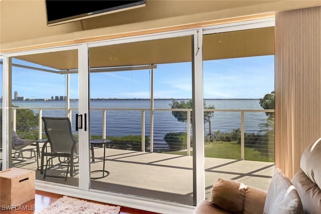 sunroom / solarium featuring a water view