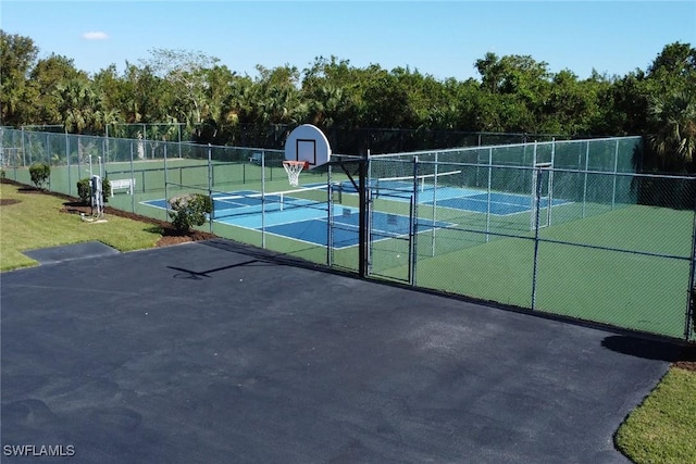 view of tennis court featuring basketball hoop