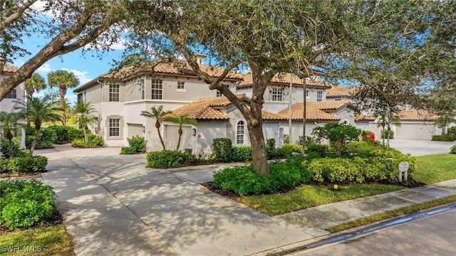 mediterranean / spanish-style home featuring a garage