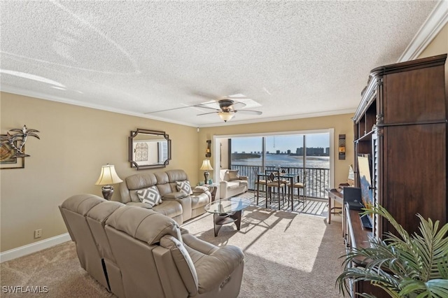 carpeted living room with ceiling fan, crown molding, a water view, and a textured ceiling