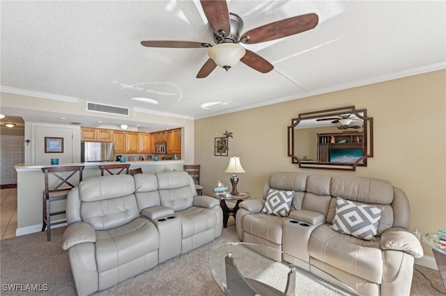 living room with crown molding, ceiling fan, light colored carpet, and a textured ceiling