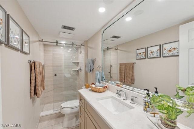 bathroom with tile patterned flooring, vanity, toilet, and a shower with door