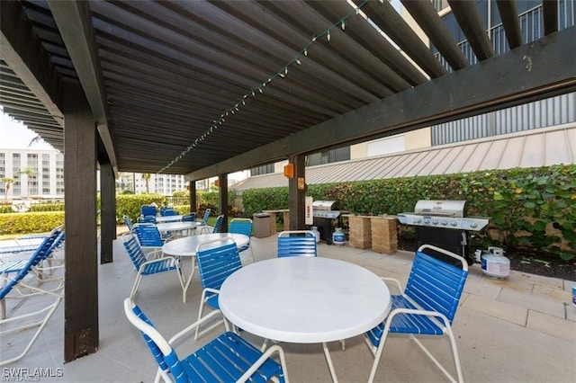 view of patio featuring area for grilling and a grill