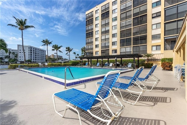 view of swimming pool with a pergola and a patio