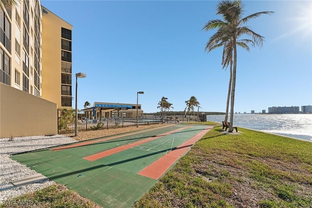 view of community featuring a lawn and a water view