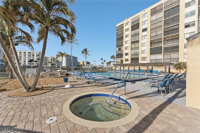 view of pool featuring a patio area and a hot tub