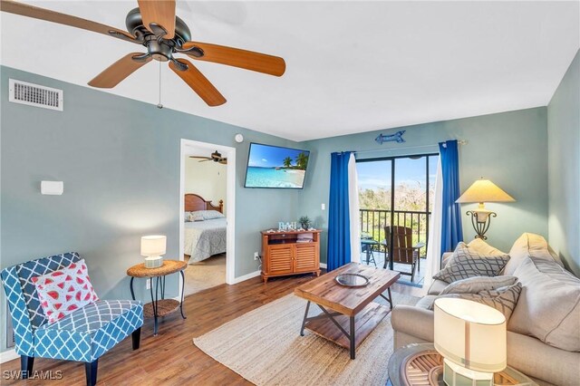 living room featuring hardwood / wood-style flooring and ceiling fan