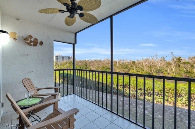 unfurnished sunroom with ceiling fan