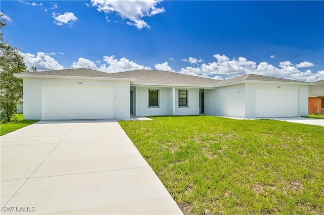 single story home featuring a garage and a front lawn