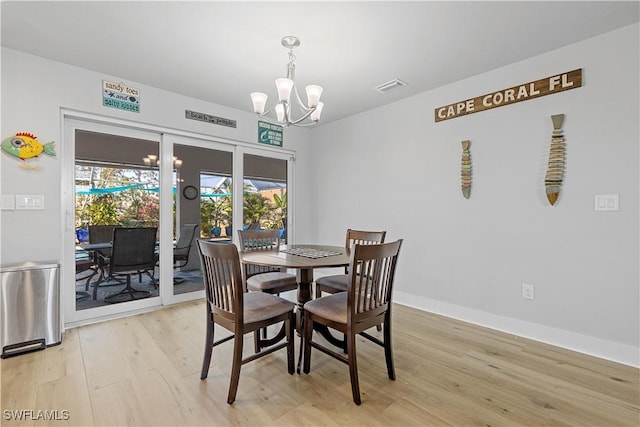 dining space featuring a chandelier and light hardwood / wood-style floors