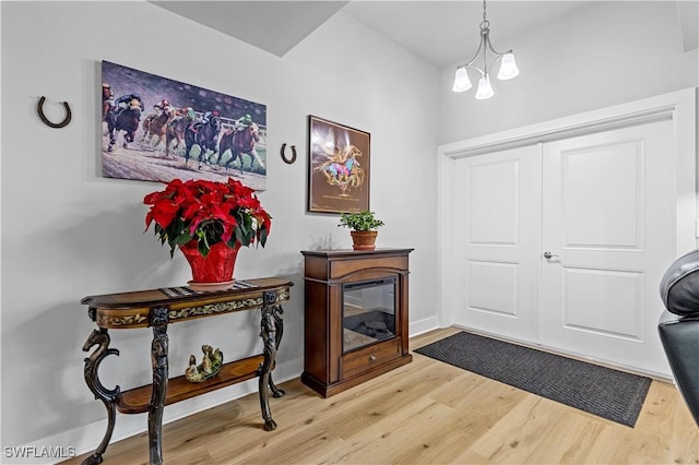 foyer featuring a chandelier and wood-type flooring