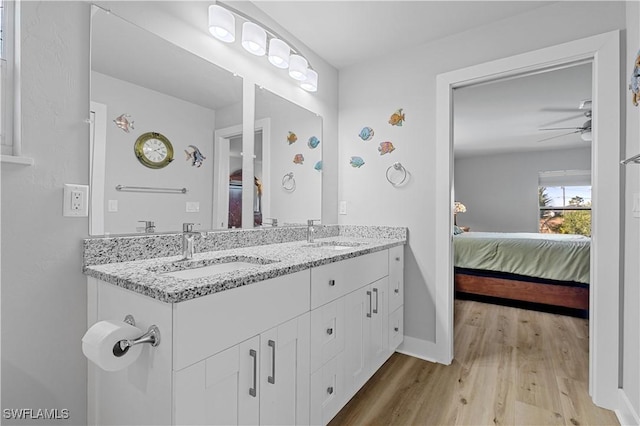 bathroom with ceiling fan, wood-type flooring, and vanity