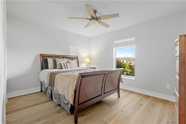 bedroom with ceiling fan and light hardwood / wood-style flooring