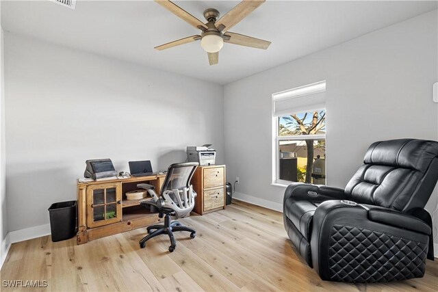 office area with light hardwood / wood-style floors and ceiling fan