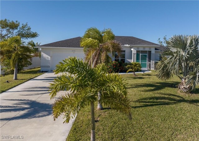 view of front of house with a front yard and a garage