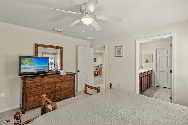 carpeted bedroom featuring ceiling fan and ensuite bathroom