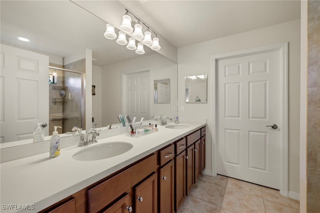 bathroom with tile patterned floors, a shower with door, and vanity