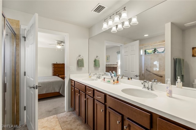 bathroom with tile patterned floors, ceiling fan, a shower with shower door, and vanity