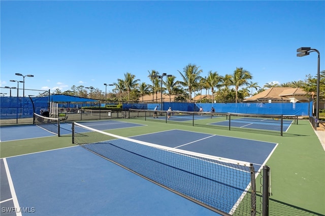 view of tennis court featuring basketball court