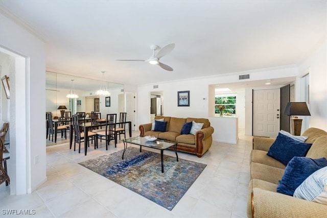 living room featuring ceiling fan, crown molding, and light tile patterned flooring