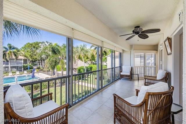 sunroom featuring ceiling fan