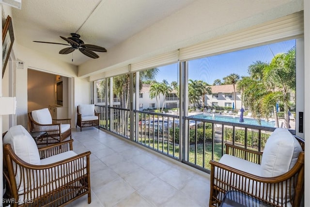 sunroom / solarium featuring ceiling fan