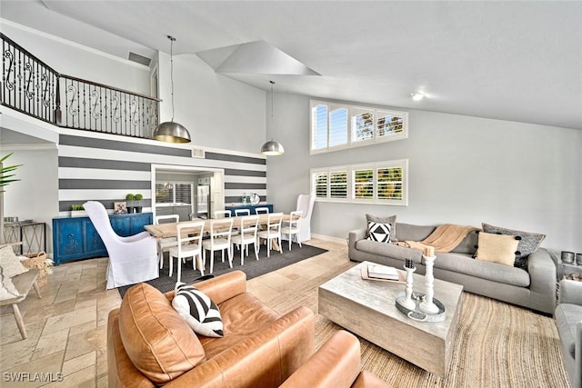 living room with high vaulted ceiling