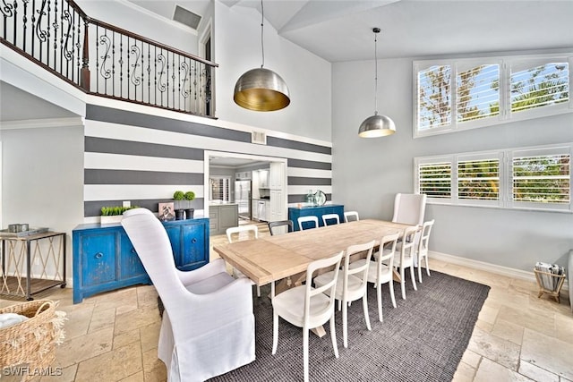 dining area with high vaulted ceiling