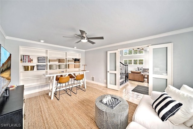 living room featuring ceiling fan and ornamental molding