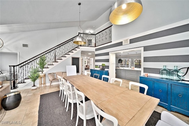 dining room featuring high vaulted ceiling