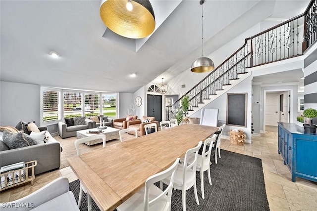 dining area with high vaulted ceiling