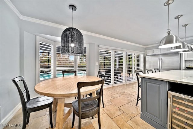 dining area featuring wine cooler and ornamental molding