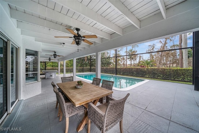 view of swimming pool with exterior kitchen and a patio