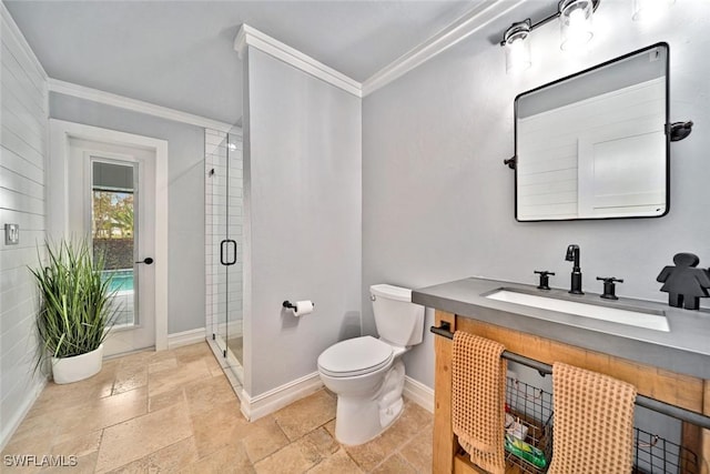 bathroom featuring vanity, toilet, a shower with door, and crown molding