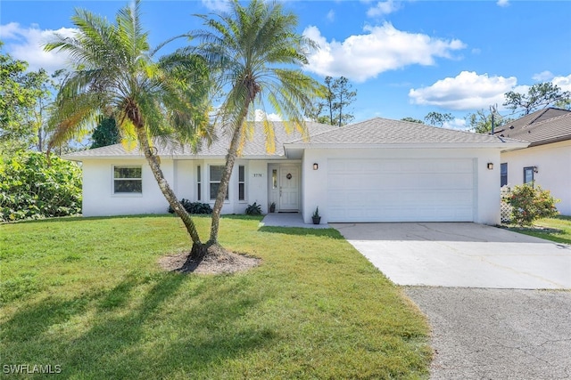 single story home with a front yard and a garage