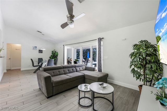 living room featuring light wood-type flooring, vaulted ceiling, plenty of natural light, and ceiling fan