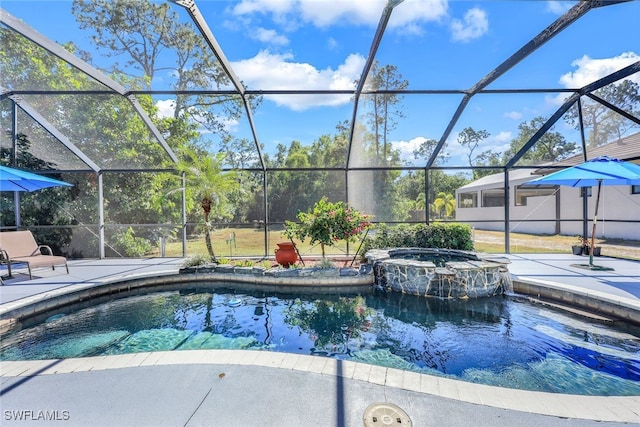 view of pool featuring glass enclosure, a patio area, and an in ground hot tub