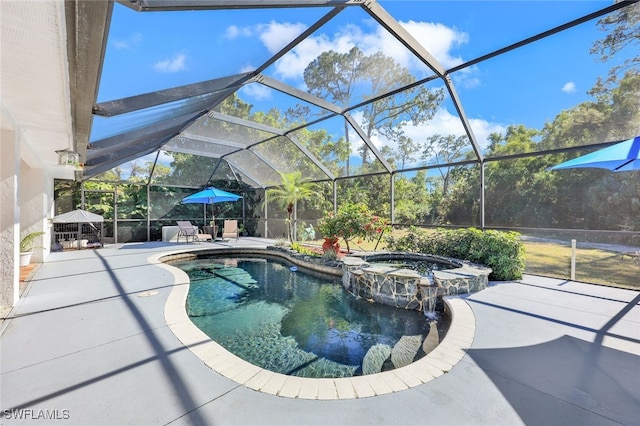 view of pool with a patio area, an in ground hot tub, and glass enclosure