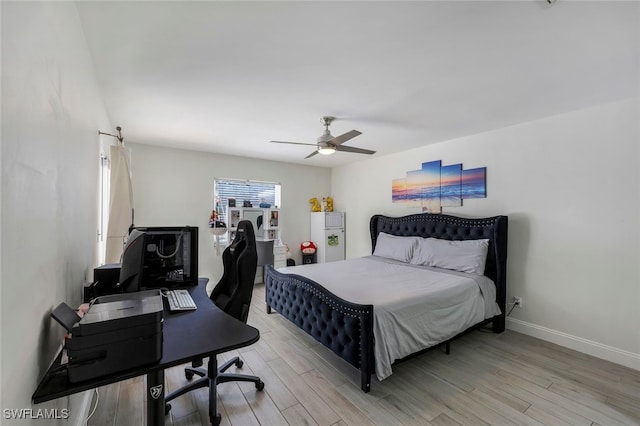 bedroom with light hardwood / wood-style floors and ceiling fan