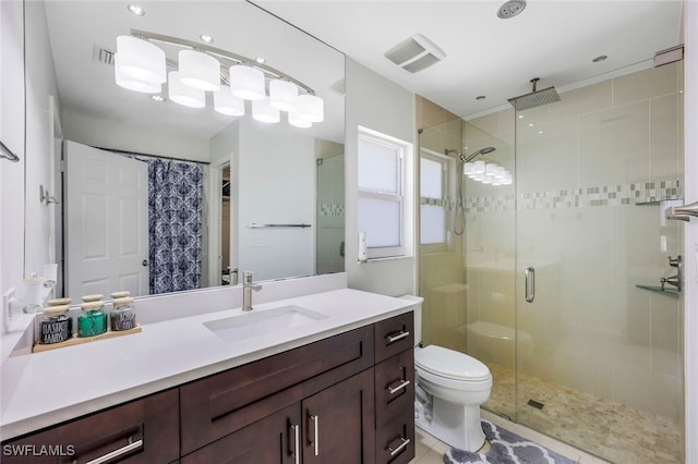 bathroom with tile patterned flooring, vanity, an enclosed shower, and toilet