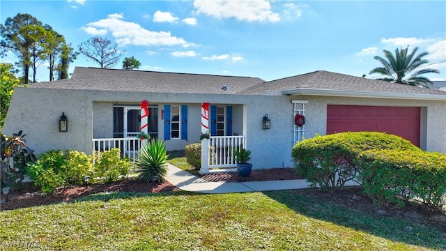 single story home with a porch, a garage, and a front yard