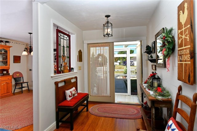 entryway featuring a chandelier and hardwood / wood-style flooring