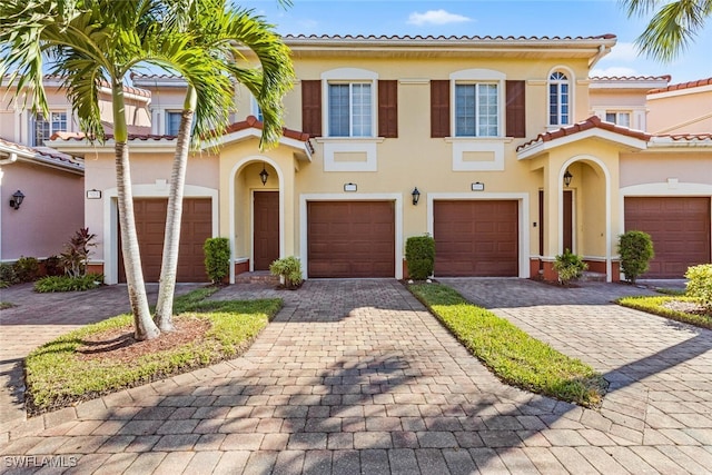 mediterranean / spanish home with a garage