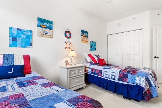 bedroom featuring ceiling fan, a closet, and light colored carpet