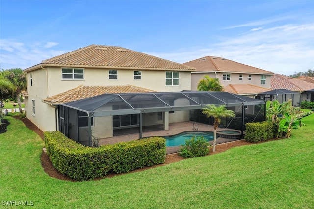 back of house with a tile roof, a pool with connected hot tub, a lawn, glass enclosure, and a patio area