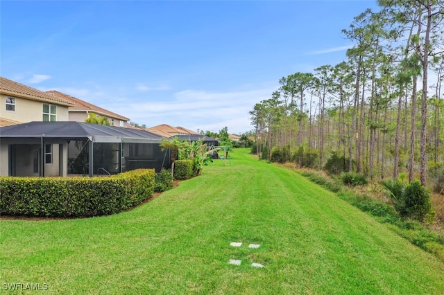 view of yard featuring glass enclosure